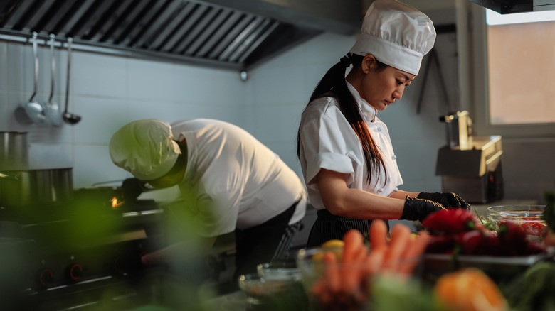 Two cooks prepping food.