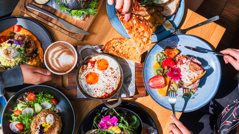 Overhead view of colorful, healthy dishes, including edible flowers