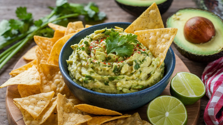 Guacamole, chips, and lime