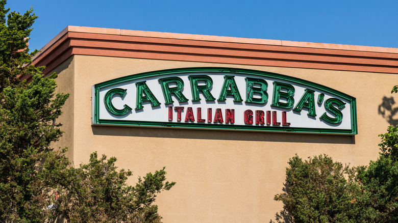 Carrabba's Italian Grill sign on building surrounded by trees