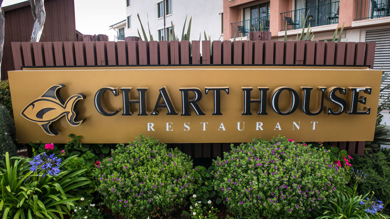 Chart House restaurant sign with bushes