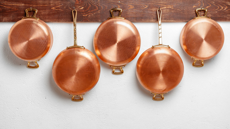 copper pans hanging on wall