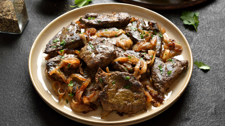 Classic liver and onions served on a white plate