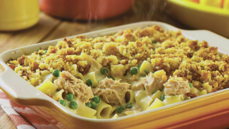 A square ceramic baking dish overflowing with tuna noodle casserole