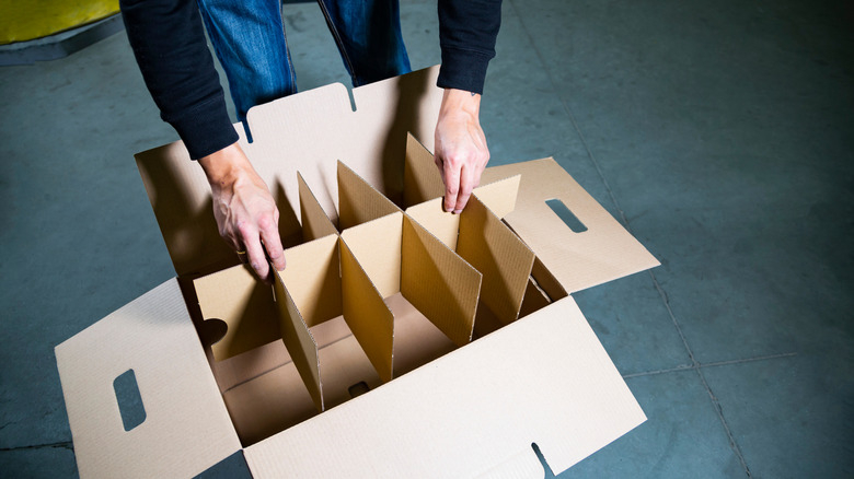 taking apart a carboard box with inserts
