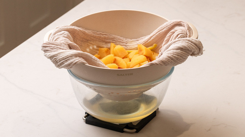 straining quince syrup through colander