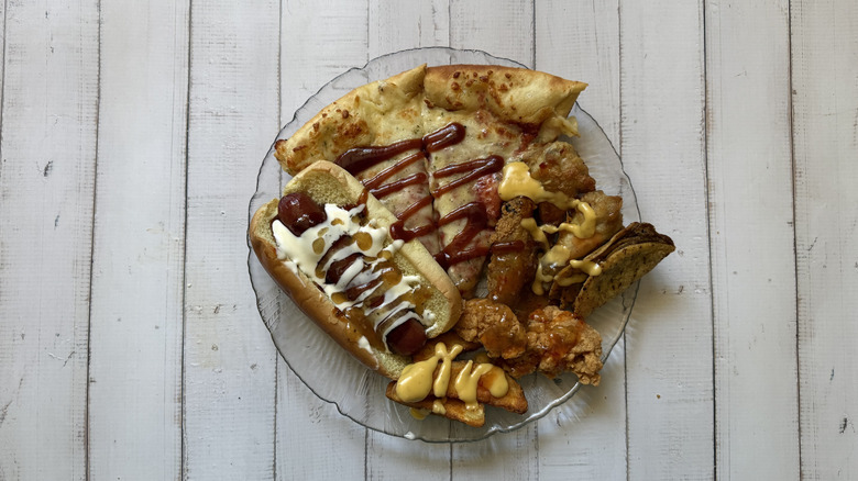 an array of 7-Eleven fare with sauces poured all over them