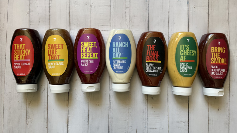 Seven sauces on wooden background