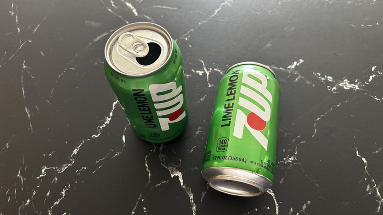 Two 7Up cans on countertop