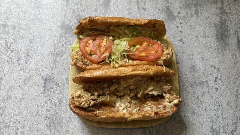 Arby's Chicken Cheesesteak and Chicken Deluxe Cheesesteak on a plate