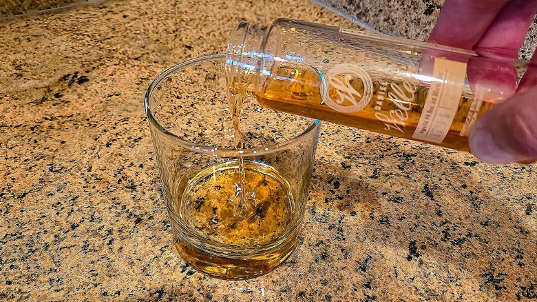 Pouring Buffalo Trace Daniel Weller Spelt Wheat into a rocks glass.