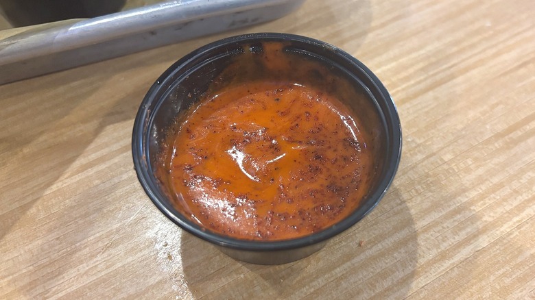 Close-up of Lemon Pepper Hot Sauce on wooden table at Buffalo Wild Wings