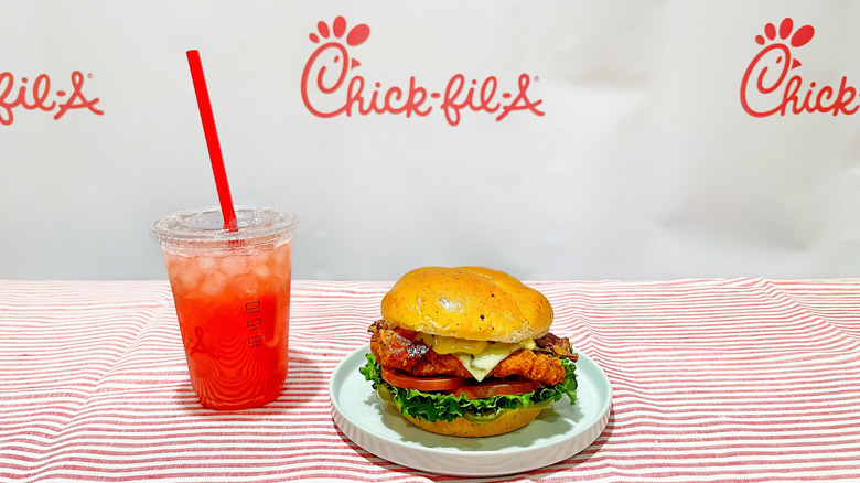 Chick-fil-A's new spicy jalapeño ranch club on a plate next to a strawberry hibiscus lemonade