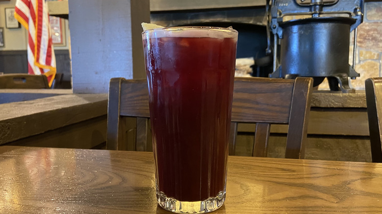 Glass of tea with flag and metal contraption in background