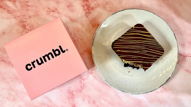 Top-down shot of Crumbl box next to Dubai Chocolate Brownie on plate