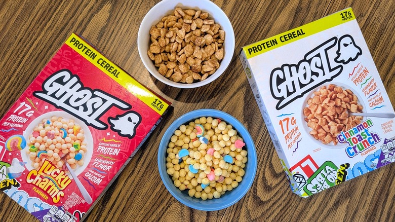 Two boxes and bowls of Ghost protein cereal on a wood table
