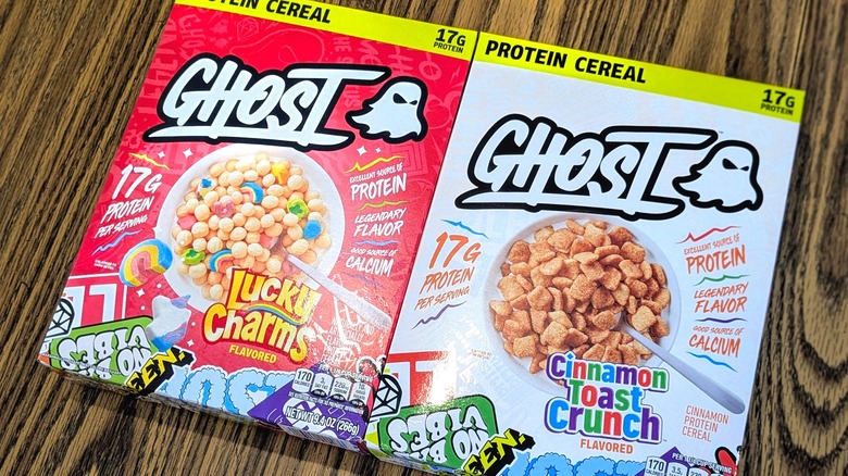 Two boxes of Ghost protein cereal on a wood table