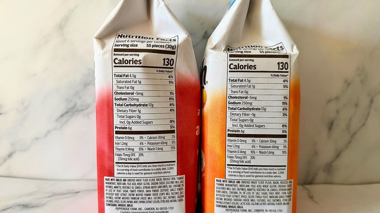 Two bags of Protein Goldfish showing nutrition labels on marble background