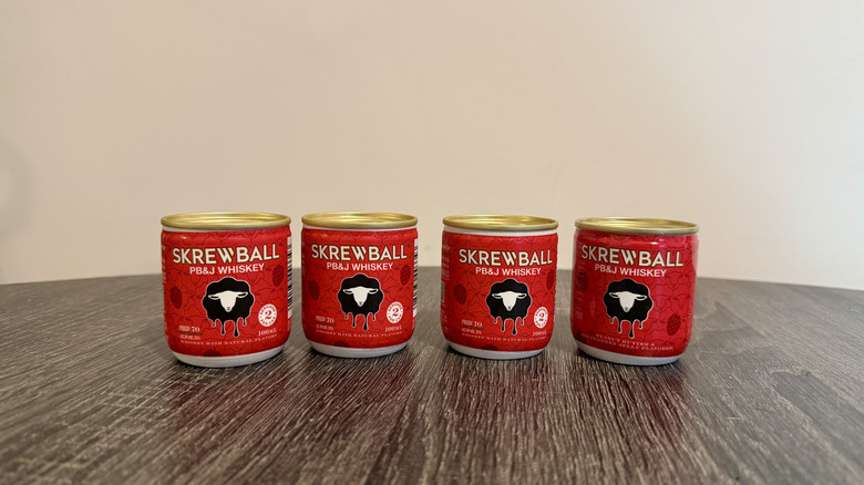 Four cans of Skrewball peanut butter and jelly whiskey