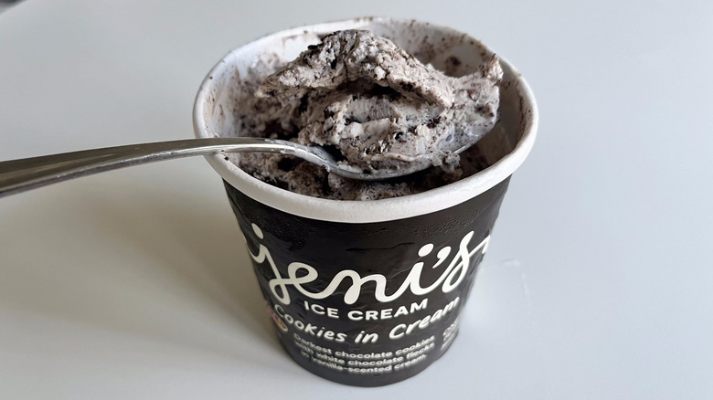 Open pint of Cookies in Cream ice cream with spoon