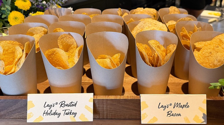 Cups of Lay's Roasted Holiday Turkey and Maple Bacon chips next to each other in wooden tray