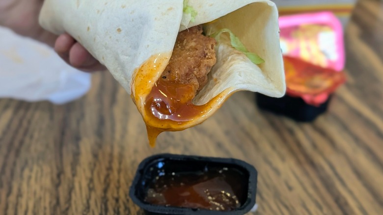 A close-up of a Snack Wrap dipped in hot honey