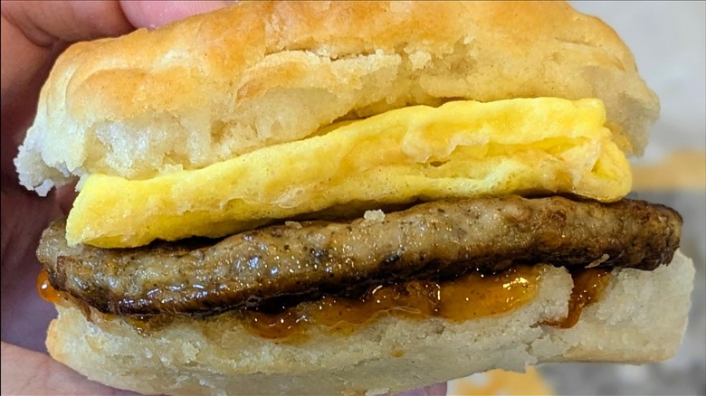 A close-up of a Sausage Egg Biscuit with Hot Honey Sauce