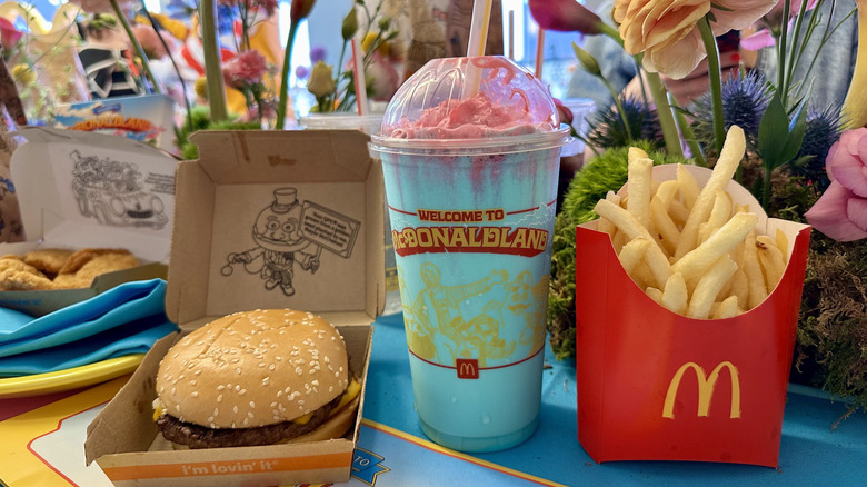 A Mt. McDonaldland Shake on a table between a quarter pounder with cheese and a box of McDonald's fries