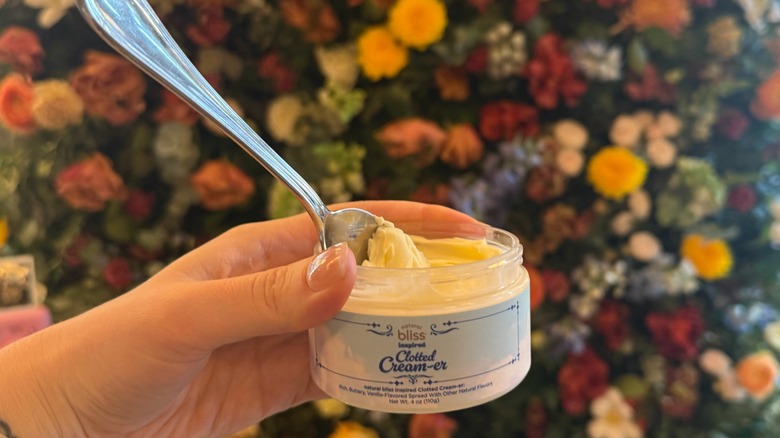 hand holder jar of Clotted Cream-er with a spoon in it