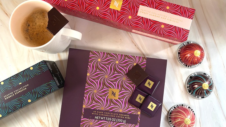 Nespresso Festive Coffee Pack boxes, chocolates, capsules, and mug with coffee