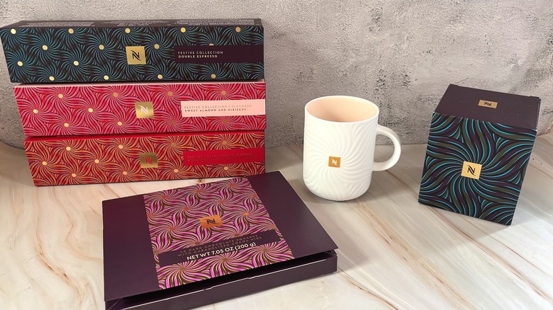 Nespresso Festive Coffee Pack boxes, mug, chocolates, and mug box on table