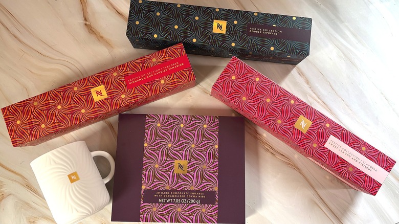 Nespresso festive holiday coffee boxes, mug, and box of chocolates