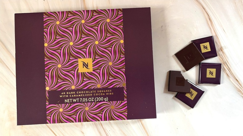 Box of Nespresso Dark Chocolate Squares with Caramelized Cocoa Nibs next to individually wrapped squares