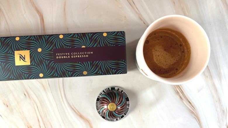 Nespresso Festive Collection Double Espresso box, capsule, and mug of brewed coffee