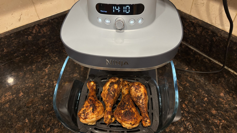 Chicken drumsticks inside of a Ninja air fryer basket