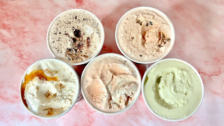 Top-down view of Salt & Straw Farmers Market Series pints on pink marble surface