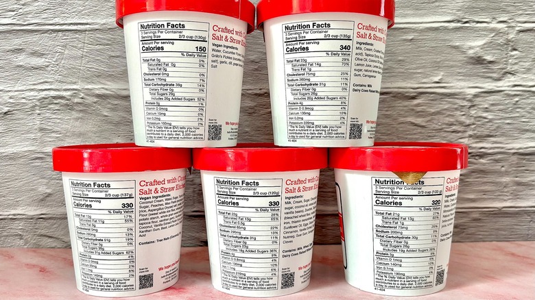Five Salt & Straw pints showing nutrition information stacked on pink table