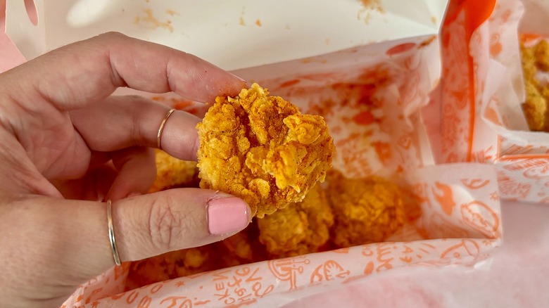 Close-up of Popeyes Ghost Pepper Dry Rub boneless wing over box