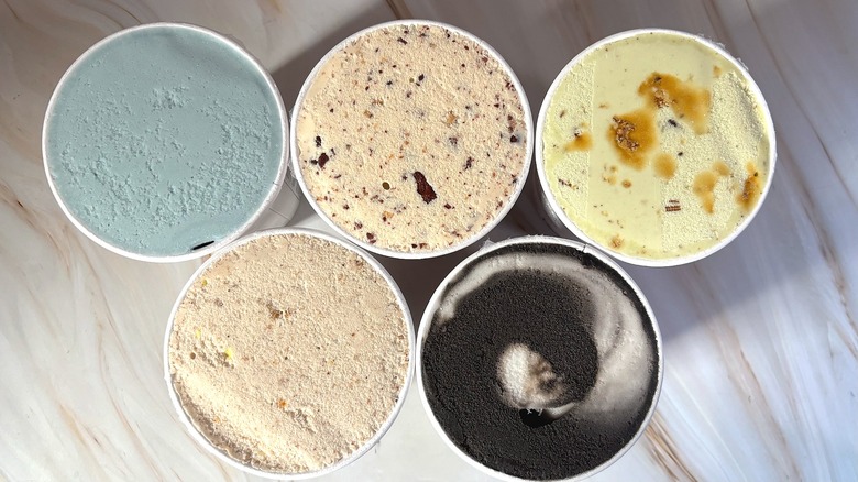 Top-down shot of open Salt & Straw Halloween pints on marbled surface