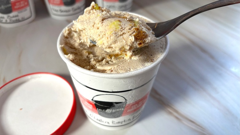 Spoonful of Salt & Straw Jack O' Lantern Pumpkin Bread ice cream over pint of ice cream