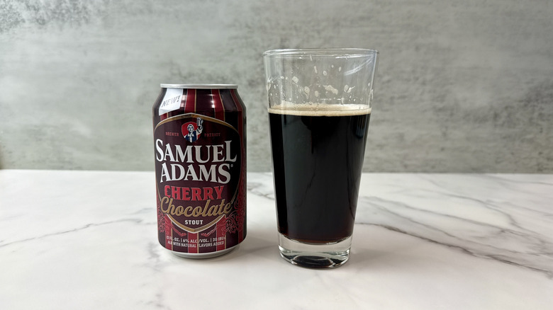 glass of sam adams cherry chocolate stout and can of stout