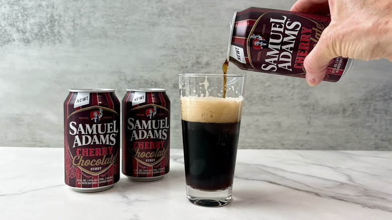 hand pouring Sam Adams cherry chocolate stout into a glass