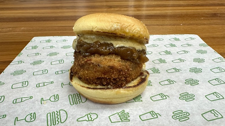 A Shake Shack French Onion 'Shroom Burger on a patterned placemat