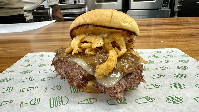 A Shake Shack French Onion Soup Burger on a paper placemat