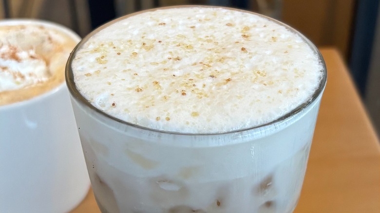 Starbucks Pecan Cold Foam sitting atop iced latte in glass