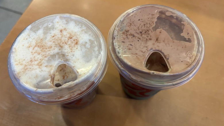 Close-up of two Starbucks Dubai drinks on wood table