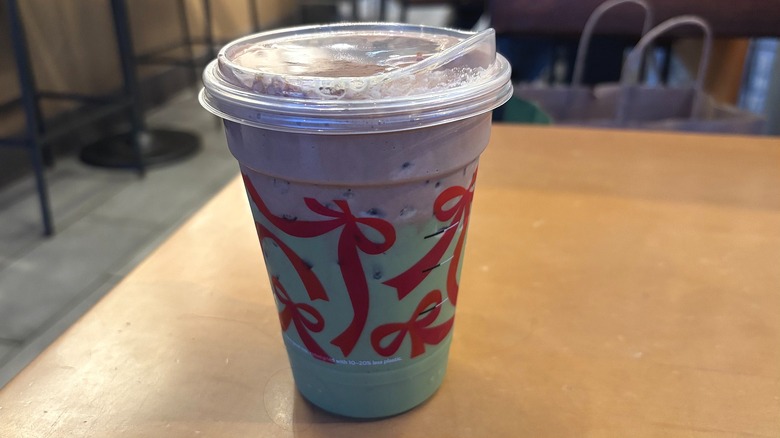 Starbucks Iced Dubai Chocolate Matcha in plastic cup on wooden table