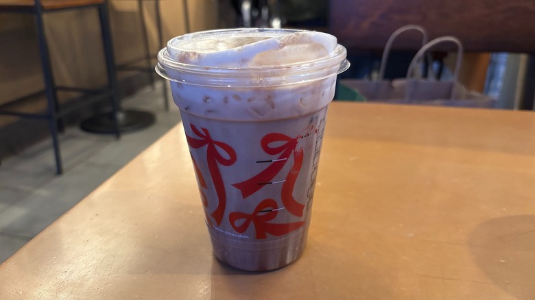 Starbucks Iced Dubai Chocolate Mocha in plastic cup on wooden table