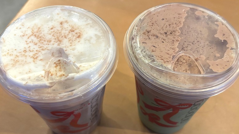 Close-up of two Starbucks Dubai drinks on wood table
