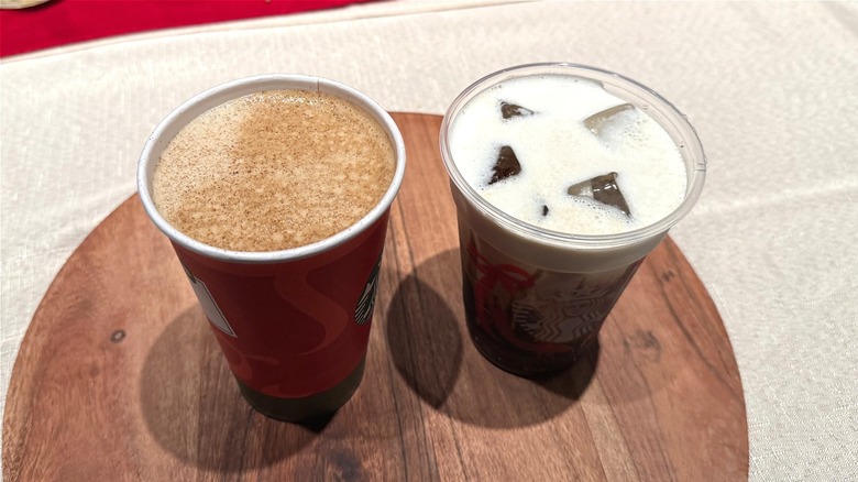 two Eggnog drinks sit on a wooden plate